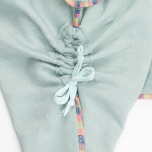 A Close Up Of The Showing the gathered pocket in our Cable Knit Grow WIth Me Romper